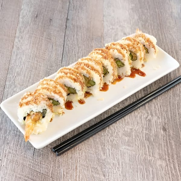 Awesome Sushi's crispy tempura shrimp rolls with sauce drizzle, served on a white plate with chopsticks.